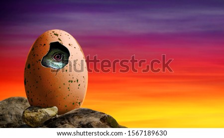 Dinosaur egg in a cliff hatching with baby dinosaur inside the egg.