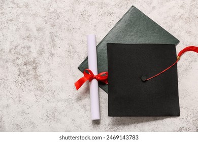 Diploma and mortar board on grey background - Powered by Shutterstock