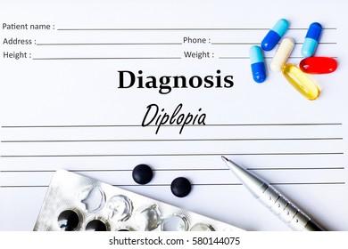 Diplopia - Diagnosis Written On A Piece Of White Paper With Medication And Pills