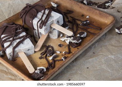 Dipped And Drizzled Chocolate On Homemade Cookies And Cream Freezer Pops.