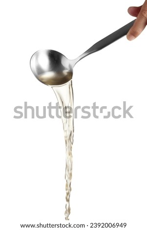 Dipper pouring noodle soup isolated on white background, Soup for sukiyaki from chicken and fish