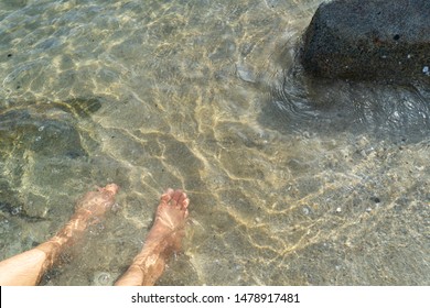 Dipping Feet On Sand In Cold Lake Water On Summer,foot Relaxing In Holiday Season At The Sea Beach.