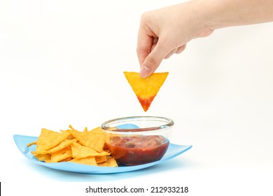 Dipping Tortilla Chips With Salsa Sauce In Dish On Isolated White Background