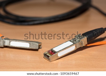 Direct attach copper cable for fast internet and network on wooden desk. Close up, selective focus
