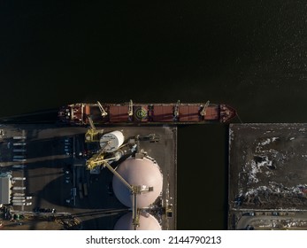 A Direct Overhead Aerial View Of A Raw Goods Agriculture Cargo Ship At A Dock In Hamilton, Ontario's Industrial Port. 