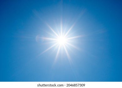 Direct Ray Of The Sun In The Blue Sky (center Position)