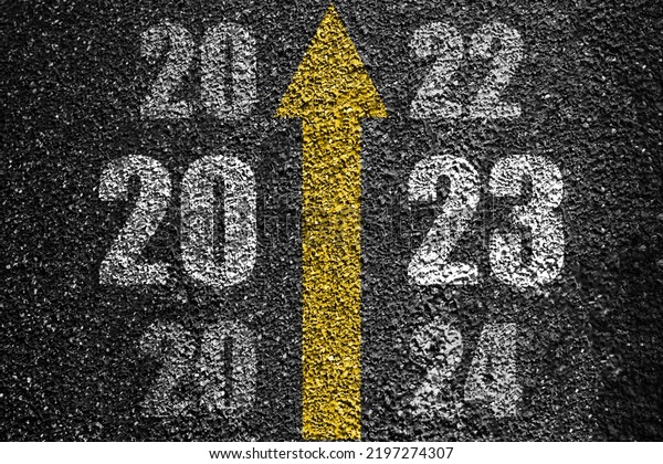 Direction to new year concept and sustainable\
development idea. Number of 2022 to 2024 on asphalt road surface\
with marking lines
