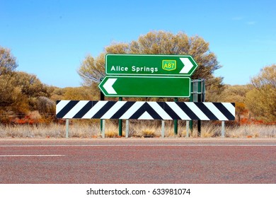 Direction Road Sign To Alice Springs And A Blank Sign Board With Copy Space At Crossroads In Northern Territory, Australia