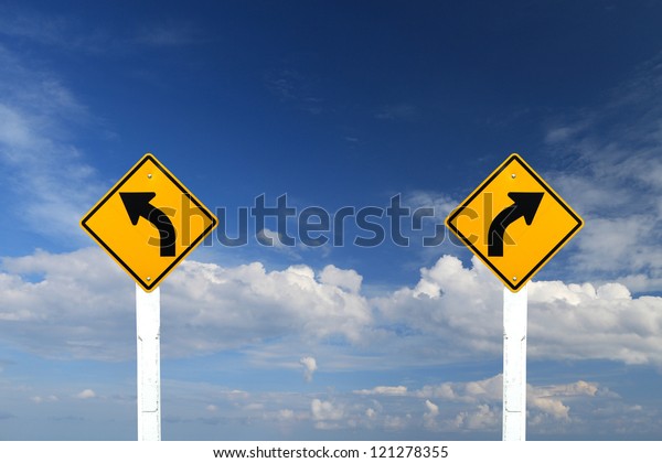 Direction sign- left and right turn warning on\
blue sky background with blank for\
text