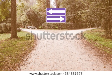  Direction sign representing a difficult decision at crossroad vintage