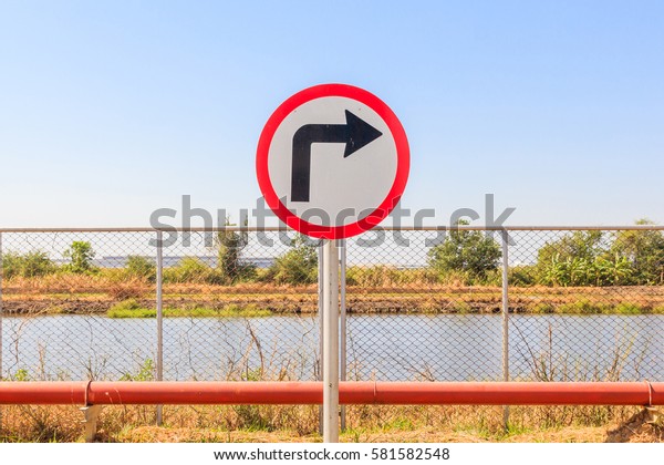 Direction sign- right turn warning on blue sky\
background with blank for\
text