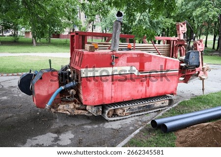 Directional drill machine or Drilling rig stands on paved asphalt. Horizontal directional drilling machine, drill rig. Trenchless method of installing underground utilities - pipe, conduit, or cables