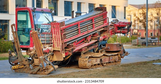 Directional drill machine. Horizontal directional drilling machine, drill rig. Drilling rig stands on paved sidewalk. Trenchless method of installing underground utilities - pipe, conduit, or cables - Shutterstock ID 2313484709