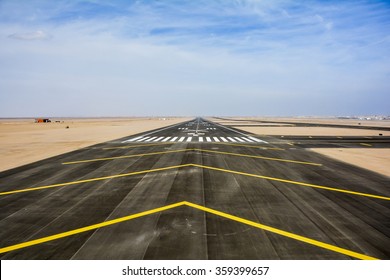 Directional Sign Markings And Landing Lights On The Tarmac Of Runway At A Commercial Airport