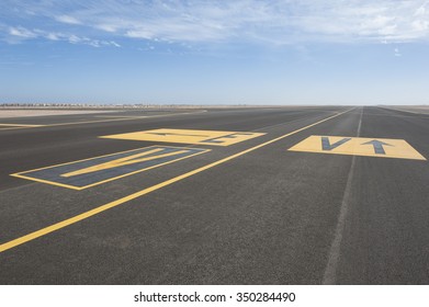 Directional Sign Markings On The Tarmac Of Runway At A Commercial Airport