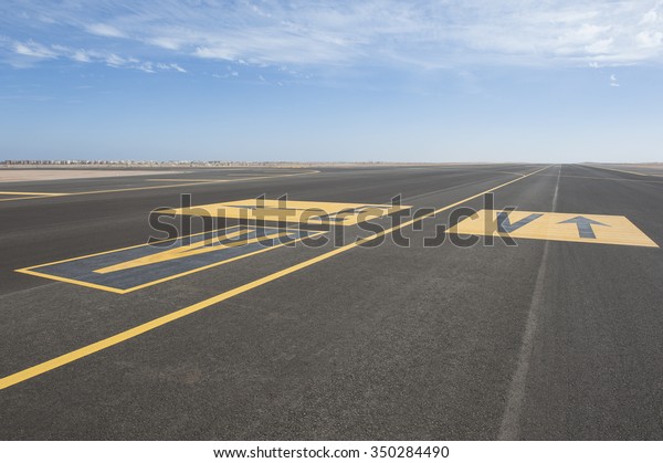 Directional sign markings on the tarmac of runway\
at a commercial\
airport