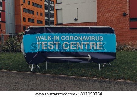 Directional sign to Walk-in Coronavirus Test Centre on a street in Birmingham, UK.