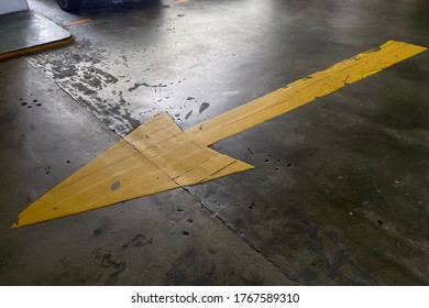 Directional yellow arrow sign on the road of the parking lots - Powered by Shutterstock