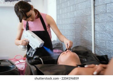 Directly Above Asian Male Lying Down For Hair Wash At Hair Salon With Eyes Closed