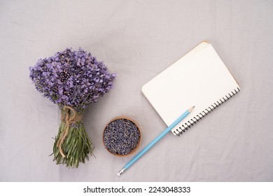 Directly above photograph of lavender flowers, paper notepad and objects to portray the topic of alternative medicine and lavender recipes. Add your text to the papers. Copy space - Shutterstock ID 2243048333