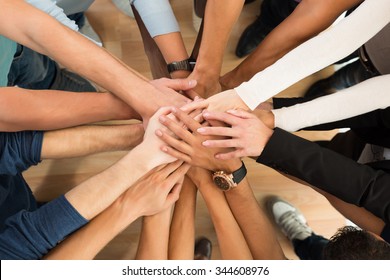 Directly above shot of creative business people piling hands over white background - Shutterstock ID 344608976