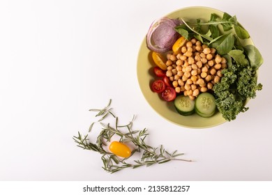 Directly Above Shot Of Fresh Healthy Food In Bowl By Herb On White Background, Copy Space. Unaltered, Food, Studio Shot, Healthy Eating, Organic.