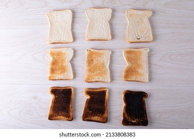 Directly Above Shot Of Toasted And Burnt Bread Slices Arranged On Table. Unaltered, Food, Slice, Arrangement And Baked Food.