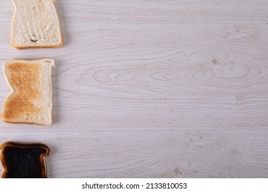 Directly Above Shot Of Toasted And Burnt Bread Slices In A Row On Table With Copy Space. Unaltered, Food, Slice, Arrangement And Baked Food.