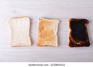 Directly Above Shot Of Toasted And Burnt Bread Slices Arranged Side By Side On Table. Unaltered, Food, Slice, Arrangement And Baked Food.