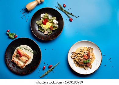 Directly Above View Of Assortment Of Italian Meals On Bright Background: Pasta, Ravioli And Lasagna 