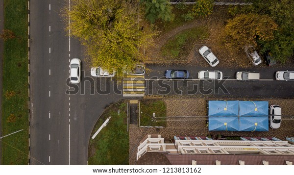 Directly\
above view of city road with cars in\
autumn