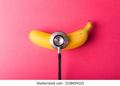Directly above view of fresh banana with stethoscope by copy space over pink background. unaltered, organic food, healthy eating and medical equipment concept. - Powered by Shutterstock