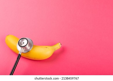 Directly above view of fresh banana with stethoscope by copy space on pink background. unaltered, organic food, healthy eating and medical equipment concept. - Powered by Shutterstock