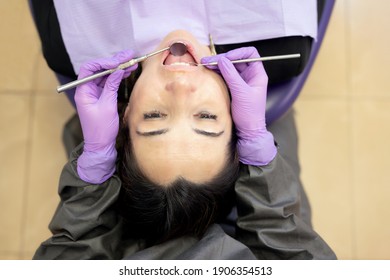 Directly Above View Of Patient In Dentist Chair Having A Dental Treatment. High Quality Photo