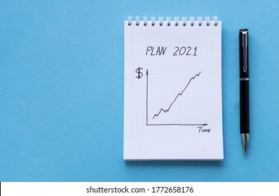 Directly Above View Of White Notepad On Blue Table. Notebook With The Schedule Shoot From The Top. Spiral Notebook Blue Background. Business Concept Planning 2021. View Through Bills And Home Finances