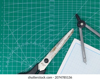 Directly High Angle Shot Of Paper, Cutting Mat, Ruler, Scalpel And Scissors