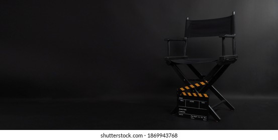 Director chair and black clapper board  or Clapperboard or movie slate use in video production or film and cinema industry. It's put on black blackground.