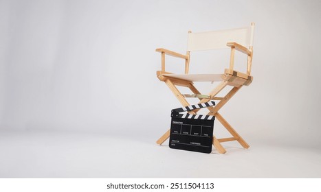 Director chair with clapper board on white background.	