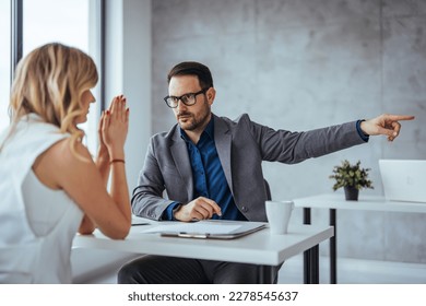 Director dissmissing worker. Getting fired. Angry boss pointing female employee on exit way. Mad male employee blaming female colleague. Get out of here. Angry boss outing his young office worker 