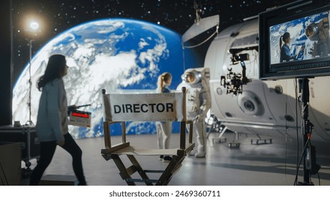 Director Filming Astronaut Scene With Digital Earth Backdrop. Actor in Harness Simulates Spacewalk for Ad Shoot. Behind-the-scenes of Virtual Production. - Powered by Shutterstock