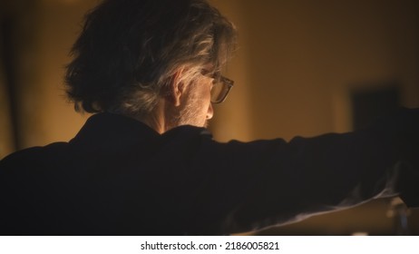 The Director Gesticulating And Talking To The Actors During A Play Rehearsal In A Dim Theater Hall