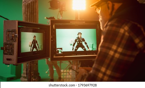 Director Looks at Displays Directs Green Screen CGI Scene with Actor Wearing Motion Tracking Suit and Head Rig. In the Big Film Studio Professional Crew Shooting Blockbuster Movie - Shutterstock ID 1793697928