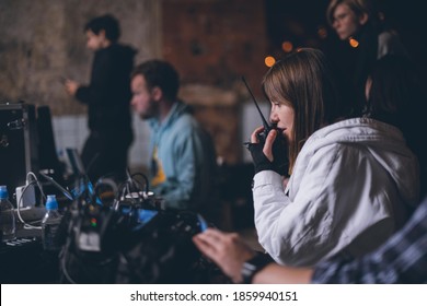 Director at work on the set. The director works with a group or with a playback while filming a movie, advertising, or a TV series. Shooting shift, equipment and group. Modern photography technique. - Shutterstock ID 1859940151