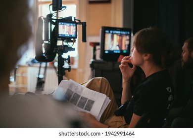 Director at work on the set. The director works with a group or with a playback while filming a movie, advertising, or a TV series. Shooting shift, equipment and group. Modern photography technique. - Shutterstock ID 1942991464