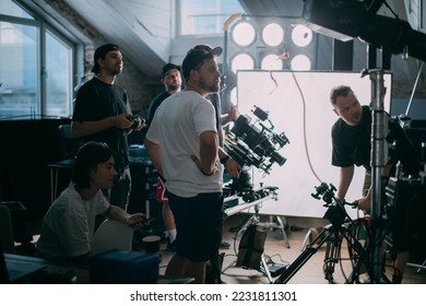 Director at work on the set. The director works with a group or with a playback while filming a movie, advertising, or a TV series. Shooting shift, equipment and group. Modern photography technique. - Shutterstock ID 2231811301