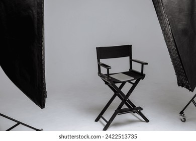 Director's chair in photo studio with laptop and flashes