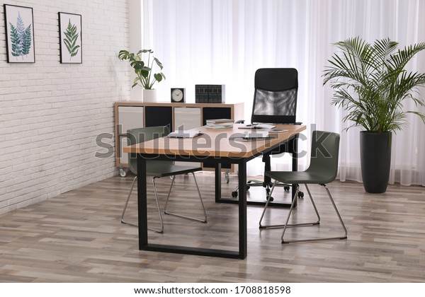 Director\'s office with large wooden table.\
Interior design