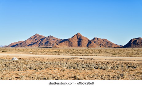 A Dirt Airstrip, For Small Planes, In Front Of Mountains In Sossusvlei Is Linking Remote Camps In The African Bush With Towns.