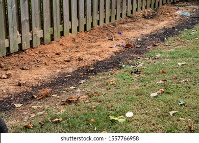 Dirt Backfills This Trench Housing A French Drain In A Backyard DIY Project To Alleviate Drainage Issues