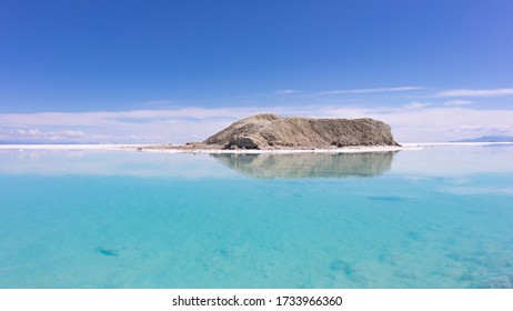 Dirt Berm Across Salt Water With Crystals